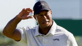 Tiger Woods holds his ball up