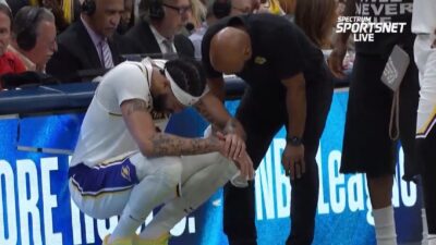 Anthony Davis with a trainer looking at him