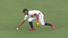 Ronald Acuna picks up a ball