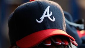 An Atlanta Braves hat on top of a glove