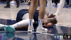 Mavericks rookie Dereck Lively on the floor holding his head