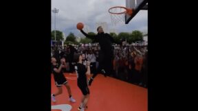 Victor Wembanyama rising up for a dunk during a Nike event