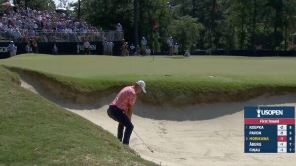 Collin Morikawa lines up a bunker shot