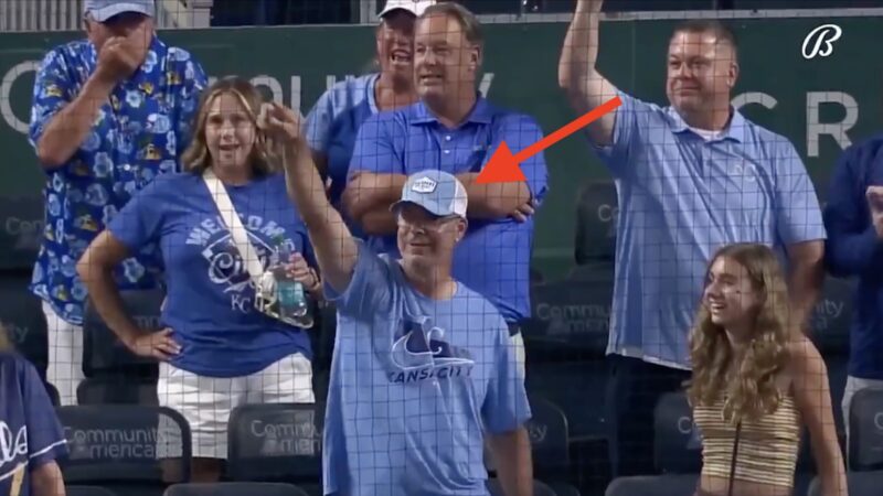 A Royals fan pointing at Bobby Witt Jr.