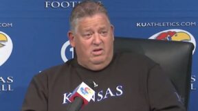 Charlie Weis talks to the media