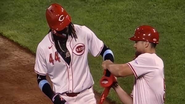 Elly De La Cruz being fitted with a sliding mitt