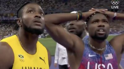 Kishane Thompson and Noah Lyles wait for their race results