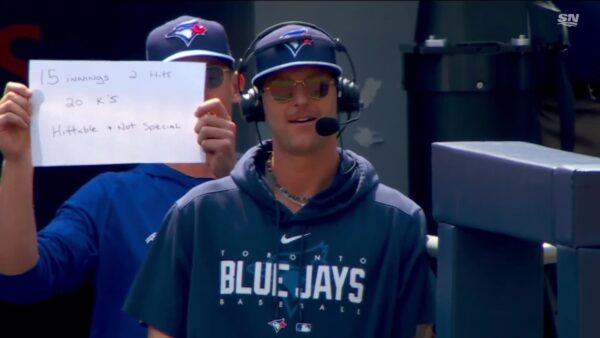 Chris Bassitt holds a Bowden Francis sign