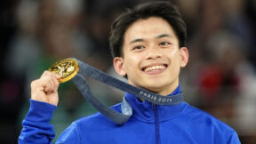 Filipino Carlos Yulo holding his gold medal at the Paris Olympics