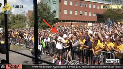 Knicks guard Miles "Deuce" McBride hugging a West Virginia student