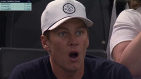 Tom Brady with his mouth open in awe while watching Simone Biles at the Paris Olympics
