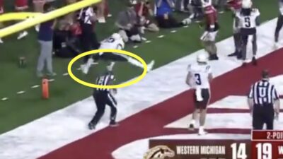 Western Michigan cornerback Nyquann Washington leapfrogs a referee during a game against Wisconsin