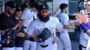 Charlie Blackmon jogs out of the dugout