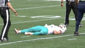 Skylar Thompson lays on the turf