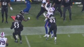 Bills QB Josh Allen making a pass while falling out of bounds against the Ravens