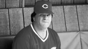 Pete Rose sitting in the Reds' dugout