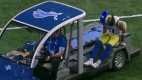 Puka Nacua being carted off the field during a Rams-Lions game