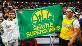 Fans holding a flag of the Seattle SuperSonics