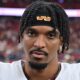 Jayden Daniels looks on without a helmet