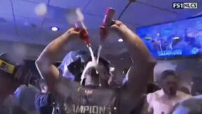 Max Muncy celebrates in the clubhouse by chugging beer