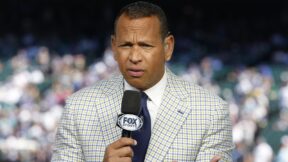 Alex Rodriguez holding a microphone