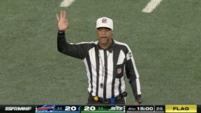 A referee makes a call during a Jets-Bills game