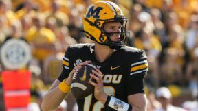 Brady Cook holds the ball