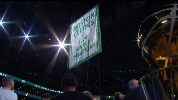 The Boston Celtics' 2024 championship banner being raised