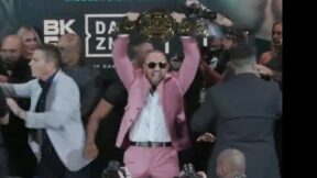 Conor McGregor holds up a belt