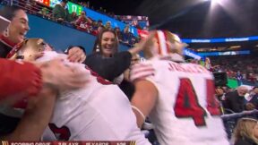 George Kittle and Kyle Juszczyk celebrating a touchdown with their wives