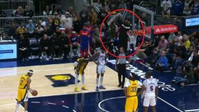 Joel Embiid waving a towel from the bench