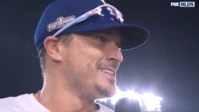 Kike Hernandez giving an interview in a Dodgers cap