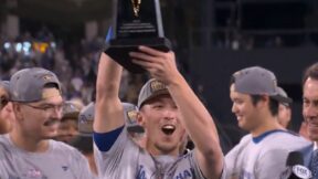 Tommy Edman holds up a trophy