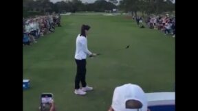 Caitlin Clark lines up a golf shot