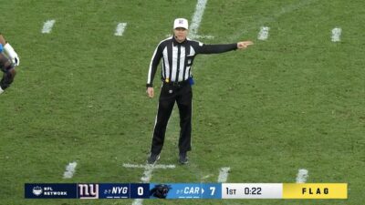 Shawn Hochuli makes a penalty call