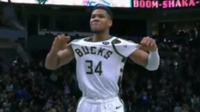 Giannis Antetokounmpo holding up his jersey