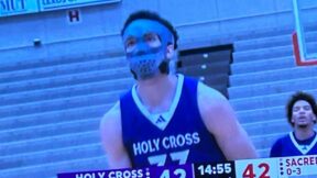 A Holy Cross player wearing a protective mask