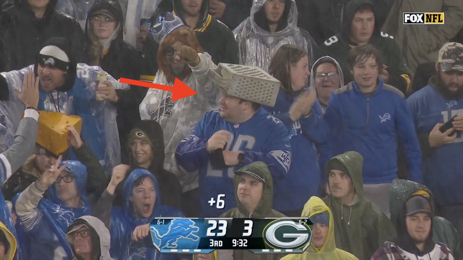 Fan wearing a cheese grater hat during a Packers-Lions game at Lambeau Field