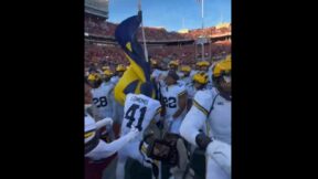 Michigan players plant a flag