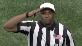 Referee Rory Bernard pays tribute to veterans with a salute