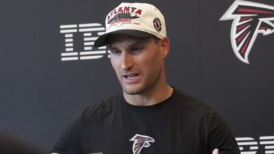 Kirk Cousins with a Falcons hat on