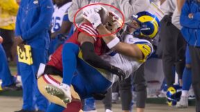 Puka Nacua catching a pass against an opponent's helmet