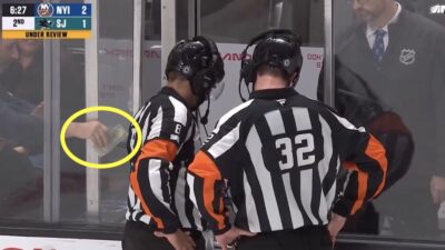 A fan tries to bribe a hockey ref