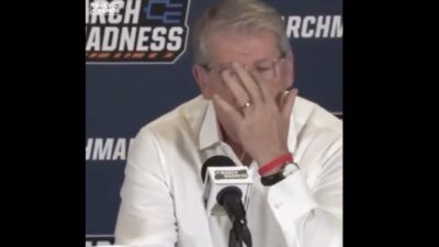 UConn women's basketball coach Geno Auriemma wiping away tears