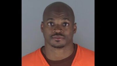 Adrian Peterson poses for a mugshot