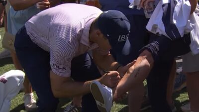 Billy Horschel autographs a fans leg