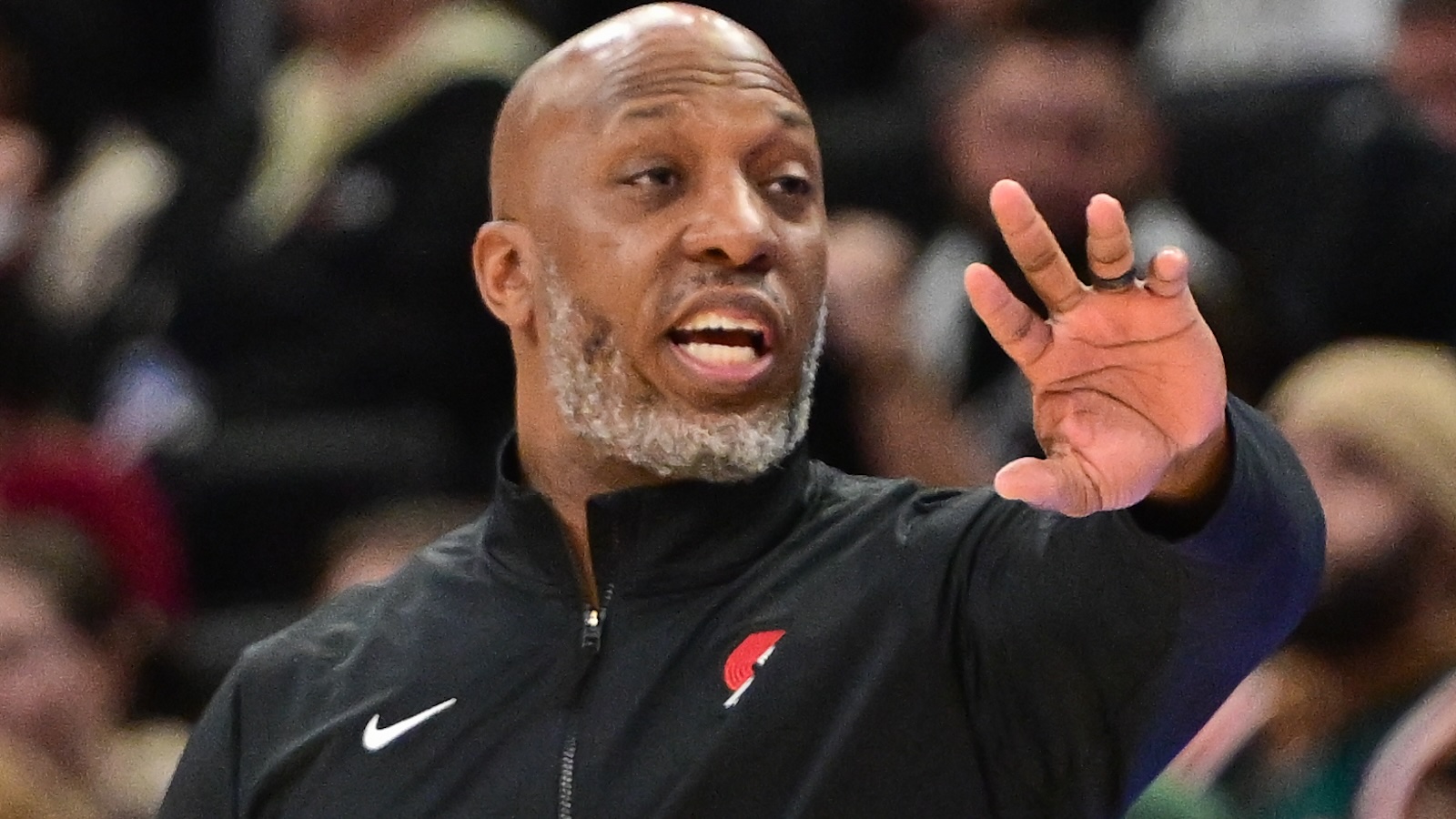 Chauncey Billups motions from the sideline