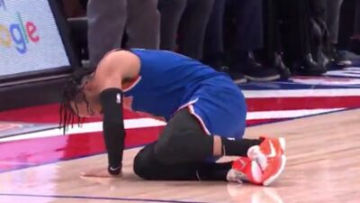 Jalen Brunson clutches his ankle in pain