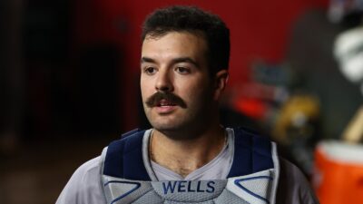 Austin Wells in the dugout wearing his catching gear