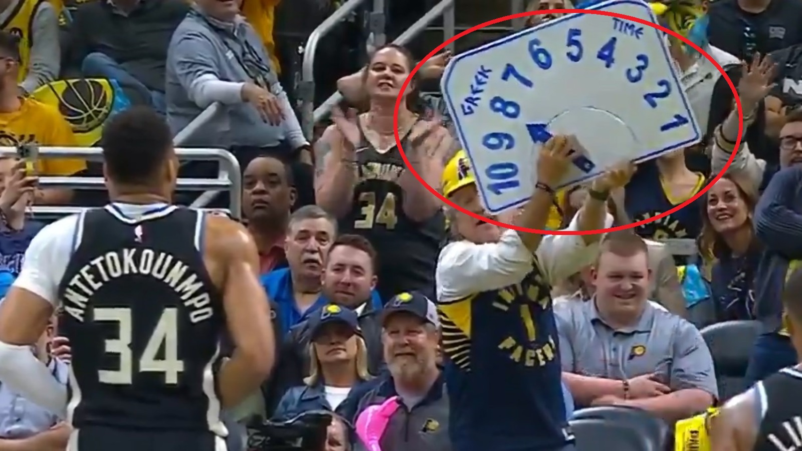 Giannis Antetokounmpo facing a clock sign